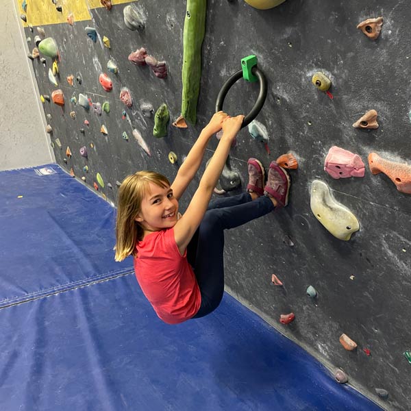 Ring clamp being used on climbing wall by young girl